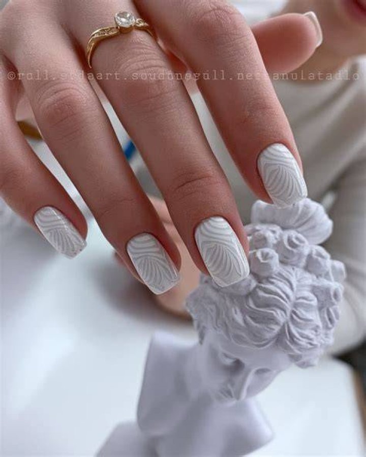 3D sculptural nail art with embellishments including pearls gems and floral appliques